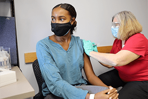 An image of a woman getting a vaccine.